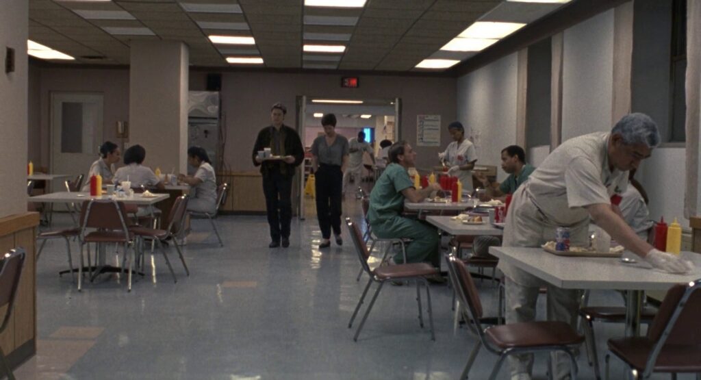 First shot of the sequence. John and Marianne enter the hospital cafeteria.